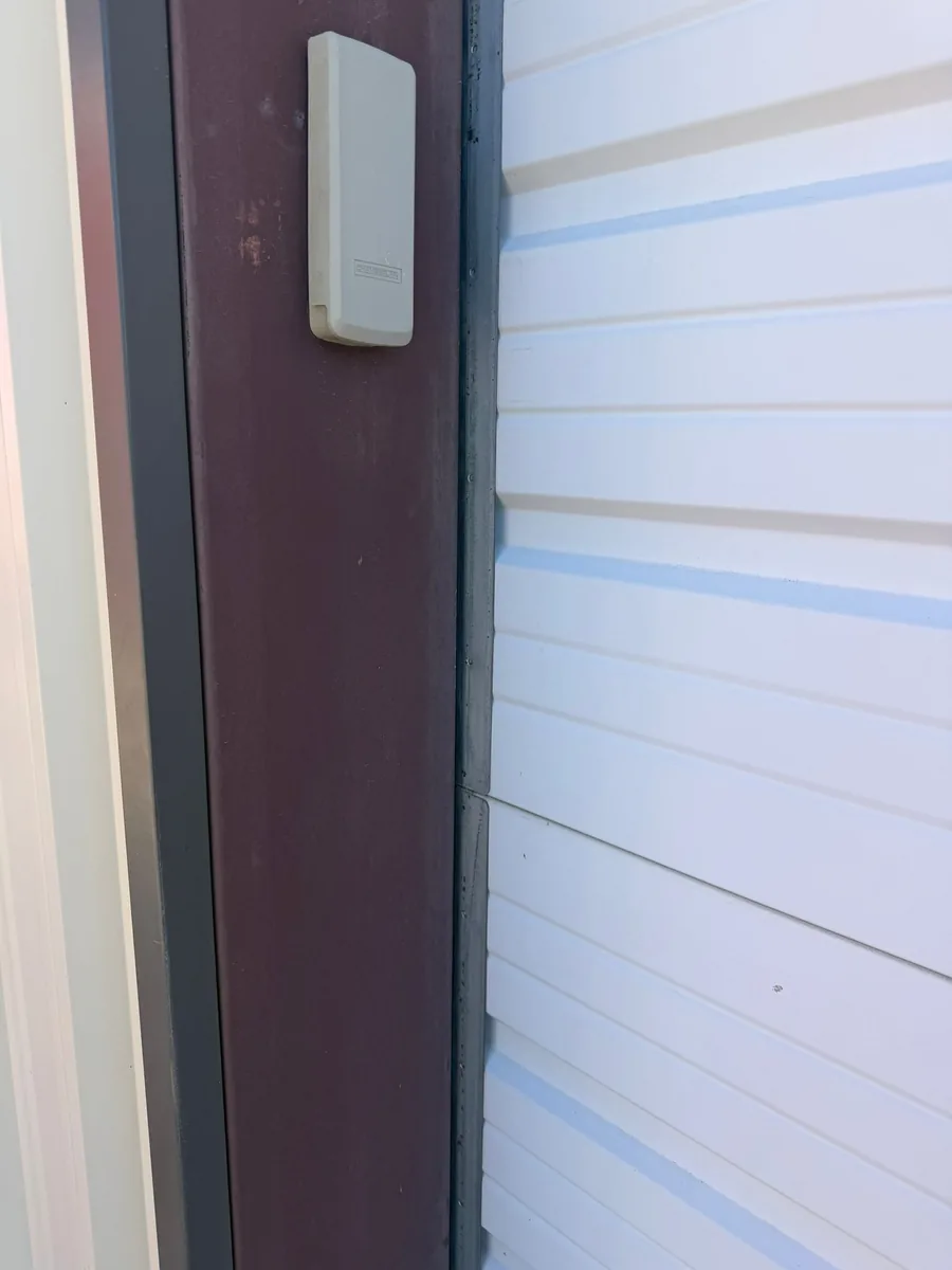 Side weather seal along the edge of a residential garage door